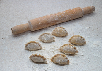 Appetizing dumplings, vareniki, ravioli, momo close-up. Boiled dough with filling. Traditional dish of Ukraine, Italy, Asia. Dumplings with meat, fish, vegetables. A hearty breakfast, lunch, dinner.