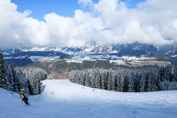 A picture from the ski resort in the austrian Alps. Snow and weather are perfect, slopes are empty. Skiing is passion in these conditions. The mountains around are great visible. 