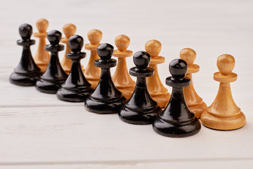 Set of wooden chess pieces. Collection of chess pawns on white background. Strategy and competition...