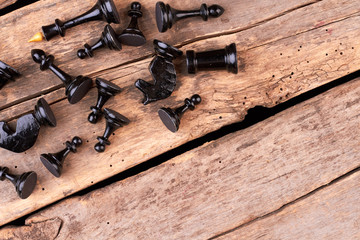 Black chess pieces with copy space. Many chess figures on old wooden boards. Determine your strategy.