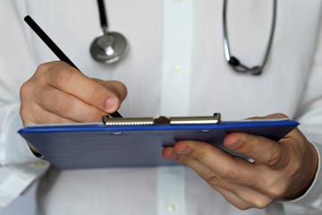 Medical exam, doctor with stethoscope writes a prescription paper. Concept of sick list, medical certificate, diagnosis, examination at the clinic, health care