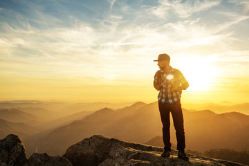 Hiker meets the sunset on the Moro rock in Sequoia national park, California, USA.