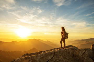 Hiker meets the sunset on the Moro rock in Sequoia national park, California, USA.
