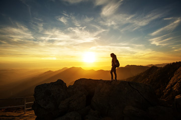 Hiker meets the sunset on the Moro rock in Sequoia national park, California, USA.