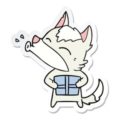 sticker of a howling wolf with christmas present