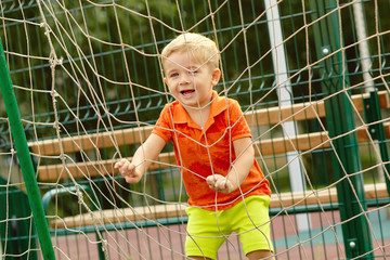 funny little boy on playground. playing child