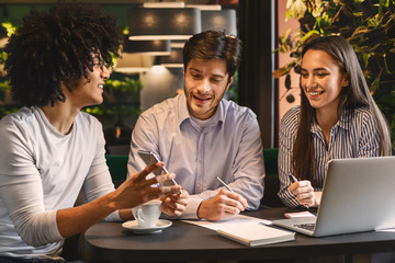 Young man sharing creative ideas with colleagues