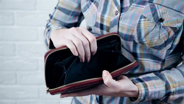 Young caucasian woman with empty wallet - broke