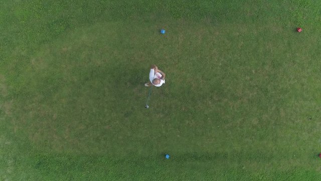 Aerial view of male golf player on golf course, boom driver shot.