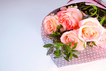 Bouquet of pink roses on light background, greeting card, place for text.