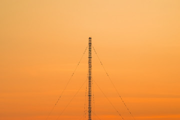 Guyed radio mast and sunset sky