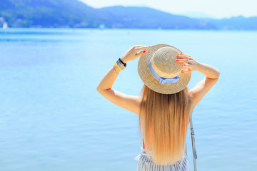 Fototapeta na wymiar Young woman relaxing on beautiful lake, vacation concept. girl h