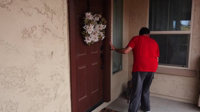 A clean video feed showing a thief stealing a backpack from the front porch of a house in broad daylight when no one is home.	 	