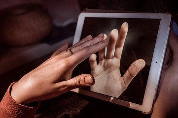 hands touching through a tablet 