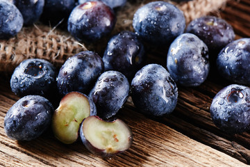 Fresh raw blueberries on wooden background close up