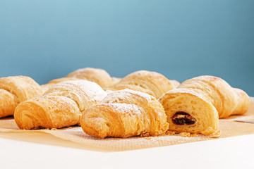 Fragrant and delicious French croissants on the kitchen table
