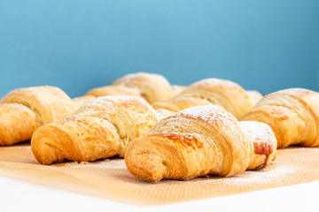 Fragrant and delicious French croissants on the kitchen table