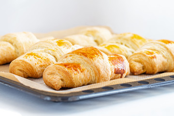Fragrant and delicious French croissants on the kitchen table