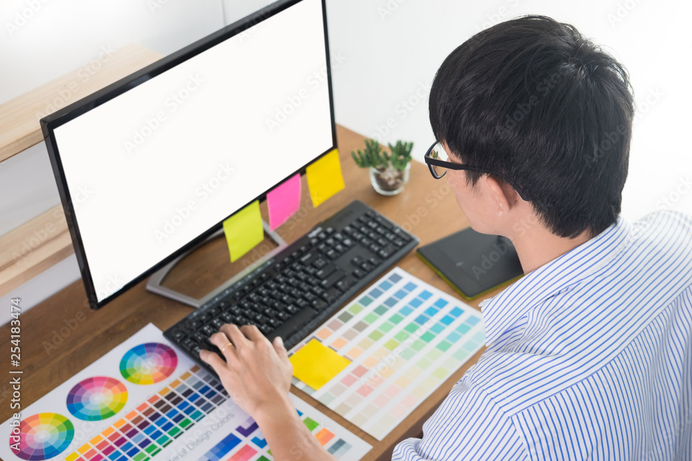Aufkleber designer editor at work drawing sketches a new project on graphic tablet and color palette sitting a