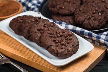 Homemade chocolate cookies on wooden table background. Food baking.