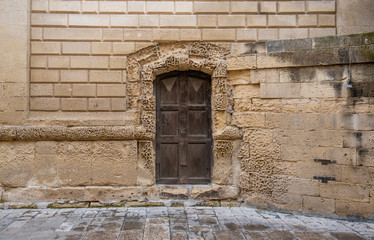 Lecce, Puglia, Italy - Medieval historical center in the old town. View and detail of an ancient gate or door. A region of Apulia