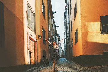 Tourist woman walking in Stockholm enjoying old streets view traveling lifestyle summer vacations...
