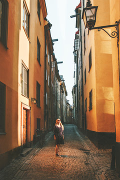 Travel in Stockholm woman walking alone lifestyle summer trip vacations in Sweden old city streets