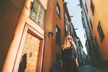 Girl tourist walking in Stockholm traveling alone fashion lifestyle summer vacations in Sweden city...