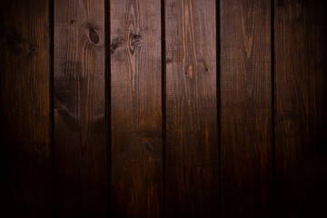 Vertical brown wooden plank desk table background texture with light. Top view, flat lay