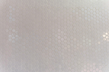 A simple white texture pattern of hexagons as a background