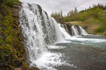 Fototapeta na wymiar Step of a small waterfall with many streams of water