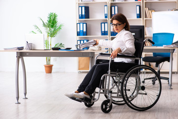 Female employee in wheel-chair at the office  
