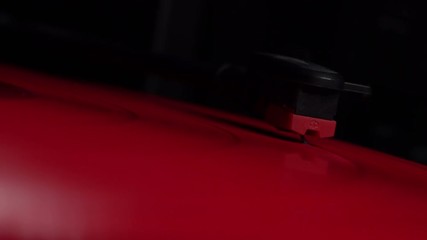 Close up of red vinyl record playing on a hi fi turntable