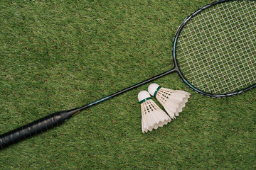 Badminton racket on the green , top view