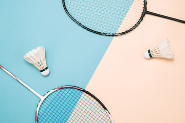 Shuttlecock and racket for playing badminton on a pástel color background. Minimalism. Concept summer razlecheny