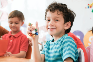 Cute boy in kindergarten classroom, kid education concept