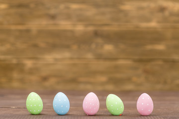 Easter eggs standing on wood background. Empty space for text