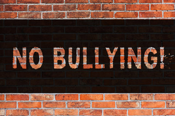 Text sign showing No Bullying. Business photo showcasing Forbidden Abuse Harassment Aggression Assault Brick Wall art like Graffiti motivational call written on the wall