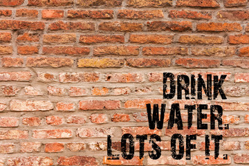 Handwriting text writing Drink Water Lots Of It. Conceptual photo drinking liquids to keep our body in great status Brick Wall art like Graffiti motivational call written on the wall