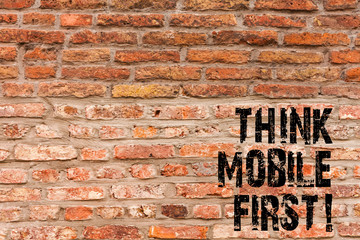 Fototapeta na wymiar Handwriting text writing Think Mobile First. Conceptual photo Handheld devises marketing target portable phones first Brick Wall art like Graffiti motivational call written on the wall