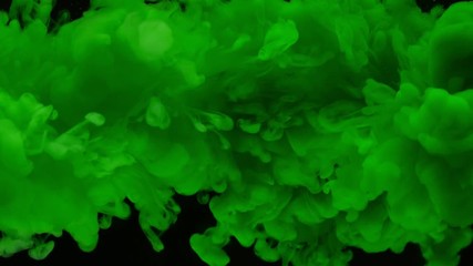 Super slow motion of coloured inks in water. Isolated on black background. Filmed on high speed cinema camera.