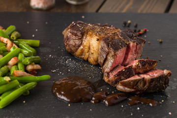 grilled steak from beef sirloin with green beans and bacon