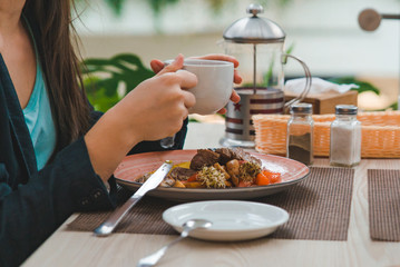 woman eating in cafe of city mall