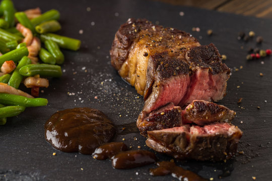grilled steak from beef sirloin with green beans and bacon