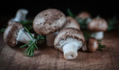 royal mushrooms on a wooden slab with rosemary