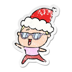 distressed sticker cartoon of a happy woman wearing spectacles wearing santa hat