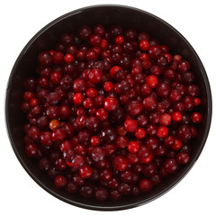 Frozen cowberry berries in a cup. Isolated on white background. View from above.