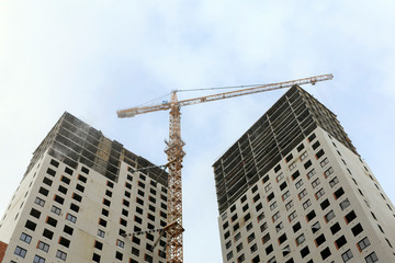 Fototapeta na wymiar Capital construction of high-rise buildings with tower cranes at the construction site
