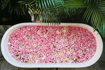 Bath tub with flowers and lemon slices