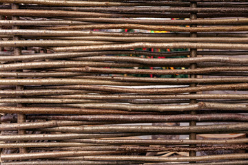 Wicker fence in the countryside. Background of the fence of twigs.